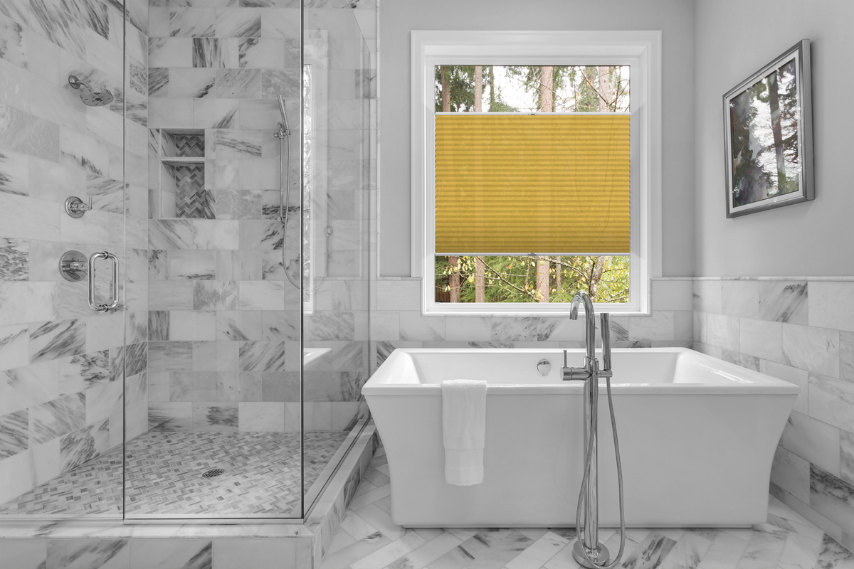 Bathroom with bathtub and shower in new luxury home with all gla