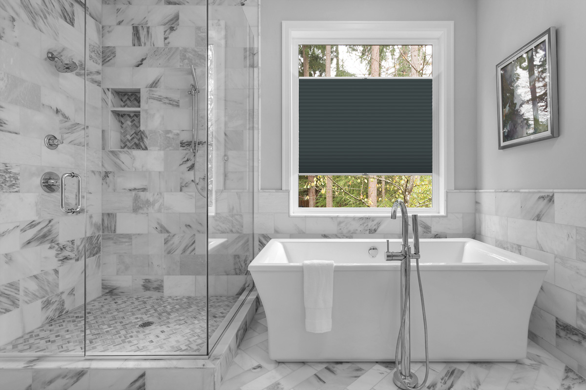 Bathroom with bathtub and shower in new luxury home with all gla