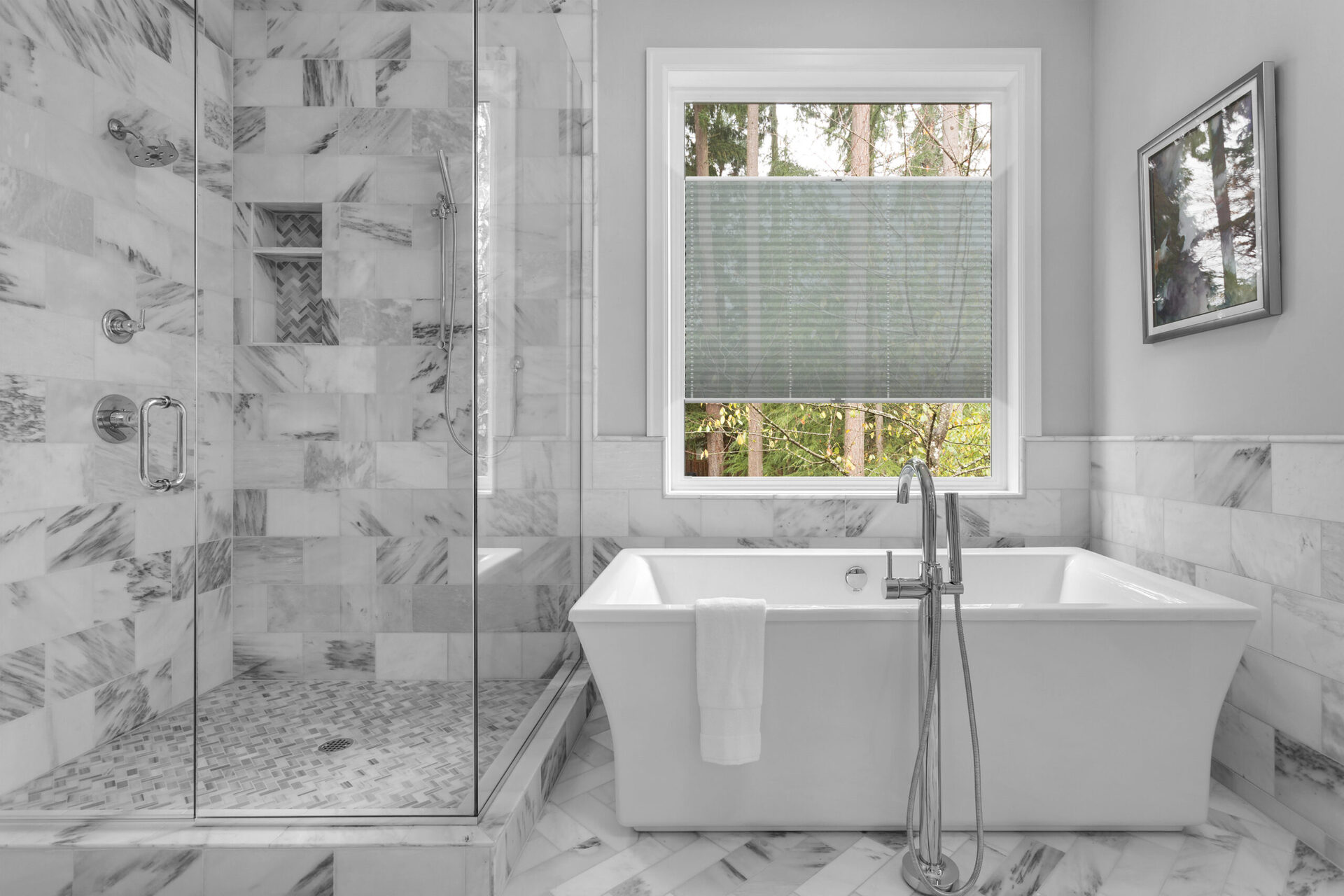 Bathroom with bathtub and shower in new luxury home with all gla